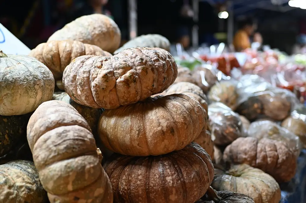 A market stall piled high with pumpkins
